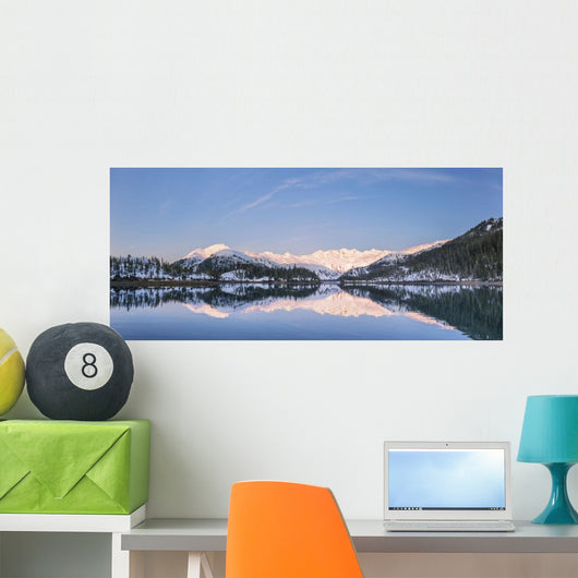 Snowy scenic reflected in the waters of Harrison Lagoon at sunrise Wall Mural
