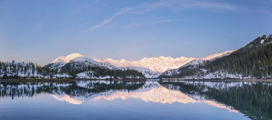 Snowy scenic reflected in the waters of Harrison Lagoon at sunrise Wall Mural