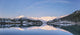 Snowy scenic reflected in the waters of Harrison Lagoon at sunrise Wall Mural
