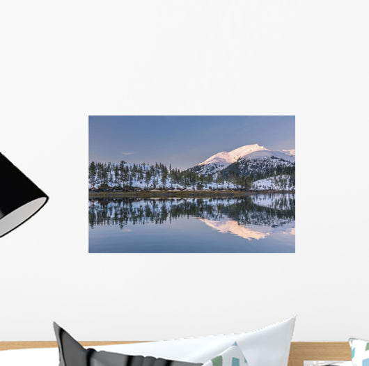 Snowy scenic reflected in the waters of Harrison Lagoon at sunrise Wall Mural