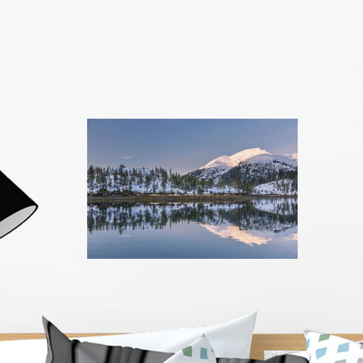 Snowy scenic reflected in the waters of Harrison Lagoon at sunrise Wall Mural