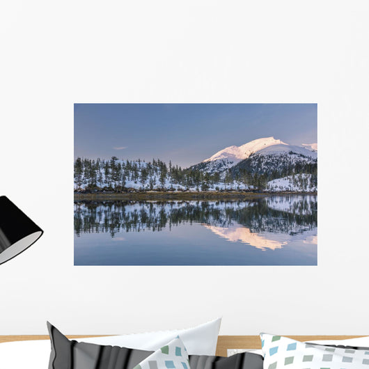 Snowy scenic reflected in the waters of Harrison Lagoon at sunrise Wall Mural