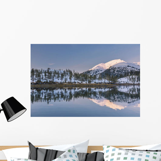Snowy scenic reflected in the waters of Harrison Lagoon at sunrise Wall Mural