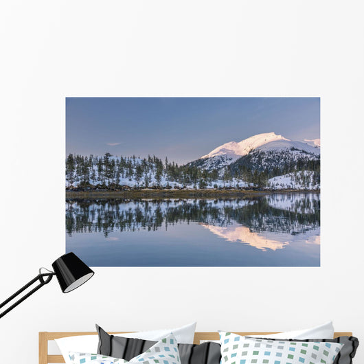 Snowy scenic reflected in the waters of Harrison Lagoon at sunrise Wall Mural