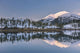 Snowy scenic reflected in the waters of Harrison Lagoon at sunrise Wall Mural