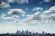 Downtown Los Angeles skyline under blue sky with scenic clouds Wall Mural