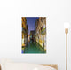 Turquoise water in a narrow canal between buildings at dusk Wall Mural
