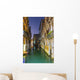Turquoise water in a narrow canal between buildings at dusk Wall Mural