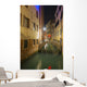 A tranquil canal between buildings with a heart shape on a footbridge Wall Mural
