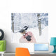 Hand feeding a black-capped chickadee sunflower seeds Wall Mural