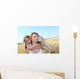 Mother drinking water in wheat field with child Wall Mural