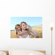Mother drinking water in wheat field with child Wall Mural