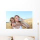 Mother drinking water in wheat field with child Wall Mural