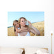 Mother drinking water in wheat field with child Wall Mural