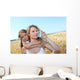 Mother drinking water in wheat field with child Wall Mural