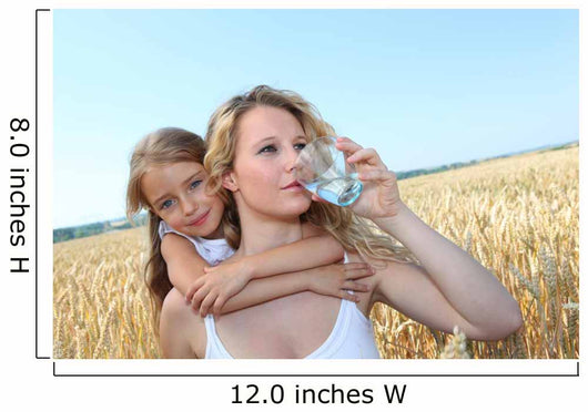 Mother drinking water in wheat field with child Wall Mural