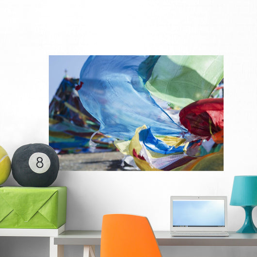 Blessing colourful Tibetan prayer flags under the blue sky Wall Mural