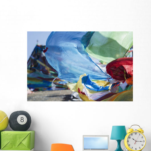 Blessing colourful Tibetan prayer flags under the blue sky Wall Mural