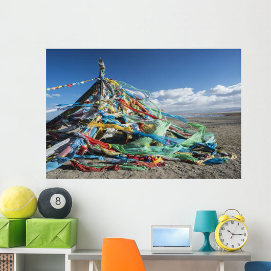 Colourful Tibetan prayer flags under the strong wind near Qinghai Lake Wall Mural