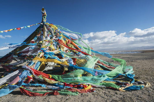 Colourful Tibetan prayer flags under the strong wind near Qinghai Lake Wall Mural