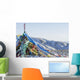 Snowy landscape with prayer flags on a high altitude mountain pass Wall Mural