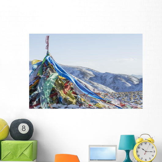 Snowy landscape with prayer flags on a high altitude mountain pass Wall Mural