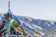 Snowy landscape with prayer flags on a high altitude mountain pass Wall Mural
