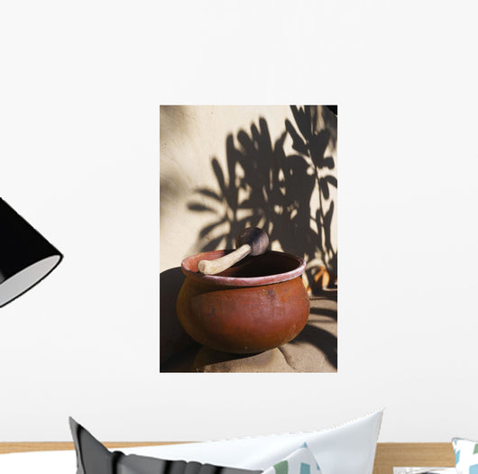 A clay bowl and wooden tool Wall Mural