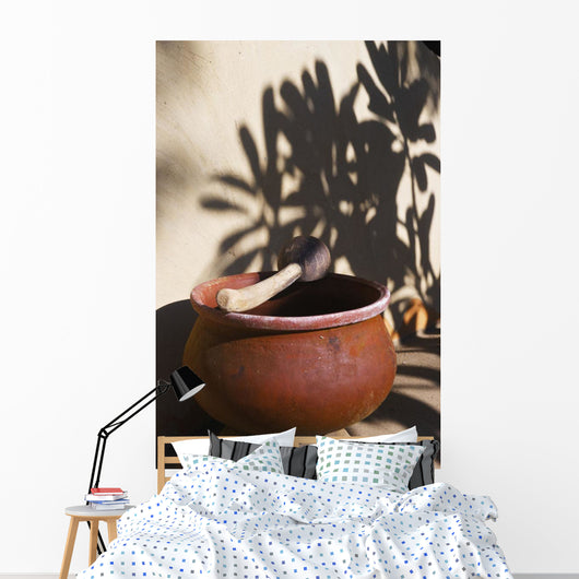 A clay bowl and wooden tool Wall Mural