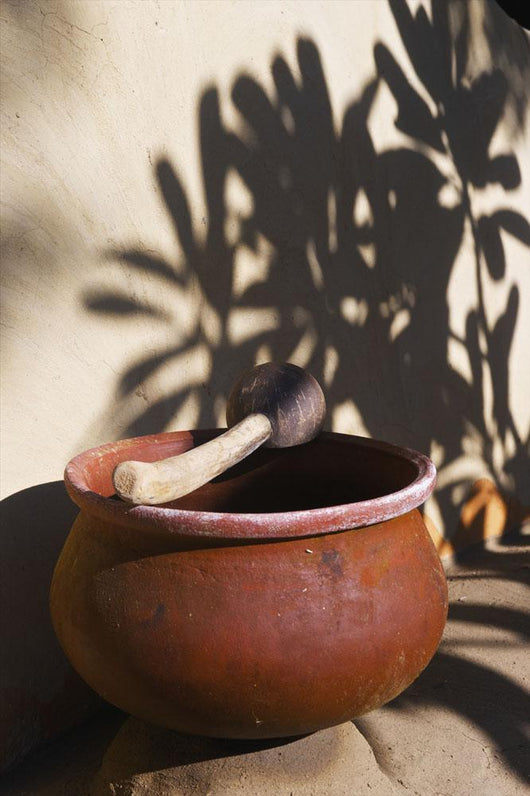 A clay bowl and wooden tool Wall Mural