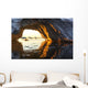 Midnight sun shines through arched iceberg near Lemaire Channel Wall Mural