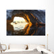 Midnight sun shines through arched iceberg near Lemaire Channel Wall Mural