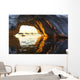 Midnight sun shines through arched iceberg near Lemaire Channel Wall Mural