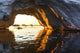 Midnight sun shines through arched iceberg near Lemaire Channel Wall Mural