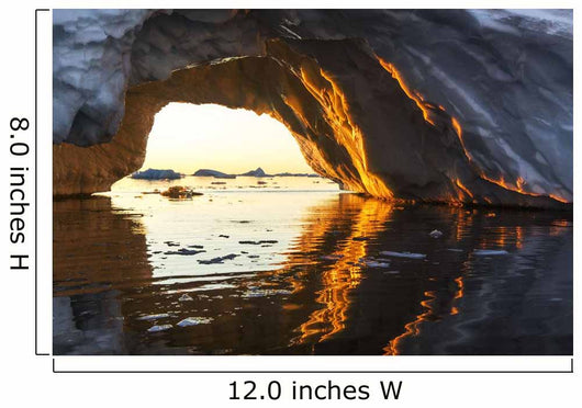 Midnight sun shines through arched iceberg near Lemaire Channel Wall Mural