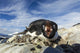 Adelie Penguin pecks at camera lens while nesting on rocky outcrop Wall Mural