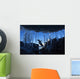 Gentoo Penguin leaping across rocks beneath wall of icicles Wall Mural
