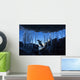 Gentoo Penguin leaping across rocks beneath wall of icicles Wall Mural
