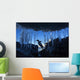 Gentoo Penguin leaping across rocks beneath wall of icicles Wall Mural