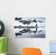 Gentoo Penguin reflected in shallow water along glacial coastline Wall Mural