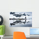 Gentoo Penguin reflected in shallow water along glacial coastline Wall Mural