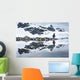 Gentoo Penguin reflected in shallow water along glacial coastline Wall Mural