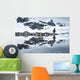 Gentoo Penguin reflected in shallow water along glacial coastline Wall Mural