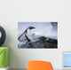 Gentoo Penguin leaping from water onto shoreline Wall Mural