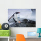 Gentoo Penguin leaping from water onto shoreline Wall Mural