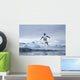 Gentoo Penguins leaping from water along Cuverville Island shoreline Wall Mural
