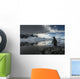 Silhouette of Gentoo Penguin standing on rocky shoreline Wall Mural