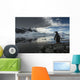 Silhouette of Gentoo Penguin standing on rocky shoreline Wall Mural