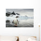 Gentoo Penguin standing in shallow water along glacial coastline Wall Mural
