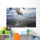 Gentoo Penguin leaping from water to rocky shoreline Wall Mural